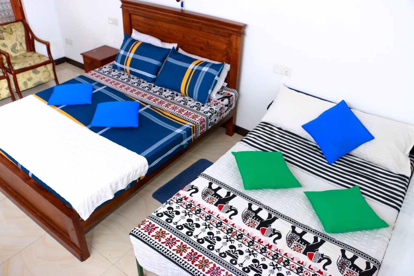 Deluxe Triple Room — Clean and bright room interior with reading lights and luggage space